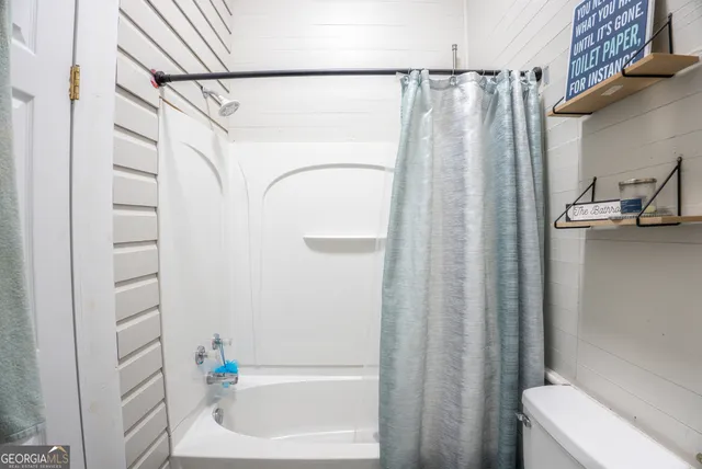 a bathroom with a shower and a tub