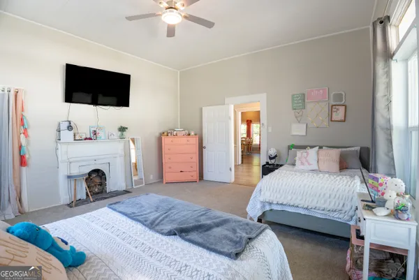 a spacious bedroom with a bed and a flat screen tv