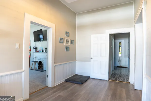 a view of a livingroom with wooden floor and a staircase