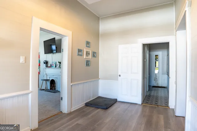 a view of a livingroom with wooden floor and a staircase