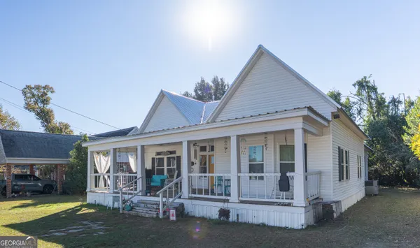 a front view of a house with a yard outdoor seating and yard