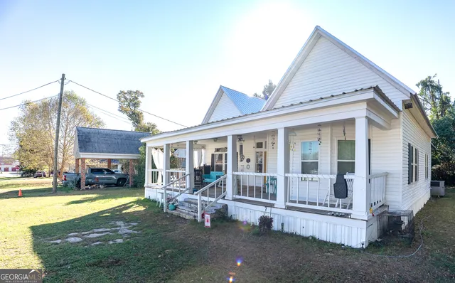 a view of a house with a swimming pool and sitting area