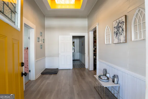 a view of a hallway with wooden floor and closet
