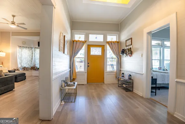 a view of a livingroom with furniture hardwood floor and a large window