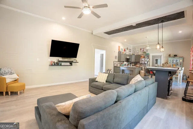 a living room with furniture and a flat screen tv