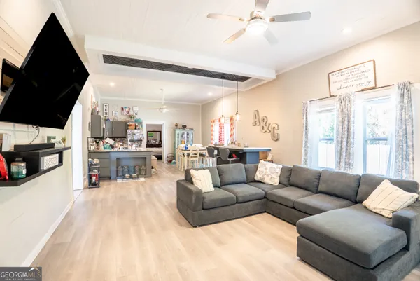 a living room with furniture and a flat screen tv