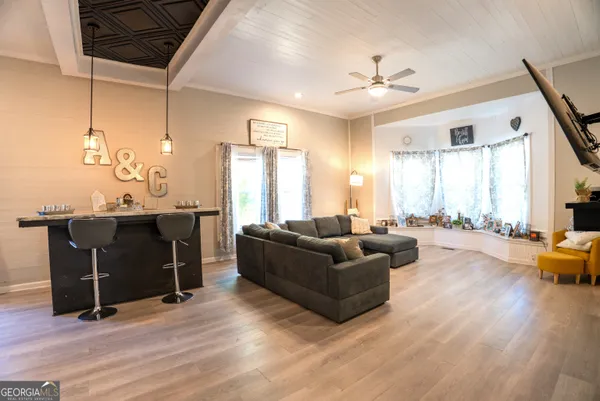 a living room with furniture window and wooden floor