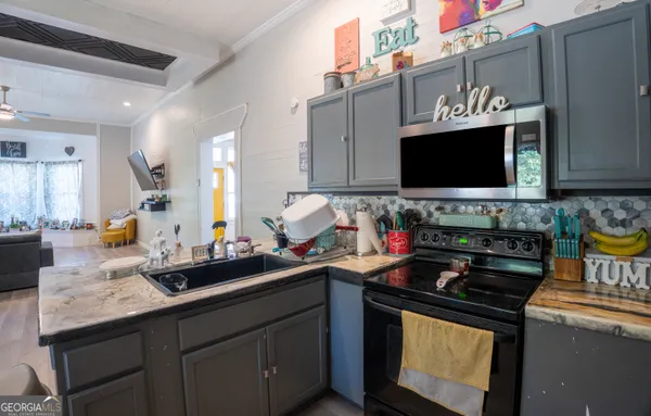 a kitchen with stainless steel appliances a sink stove and microwave