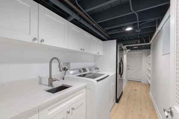 a kitchen with sink a faucet and appliances