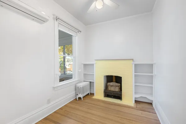 a view of a livingroom with a fireplace and window
