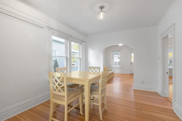 a view of a dining room with furniture and wooden floor