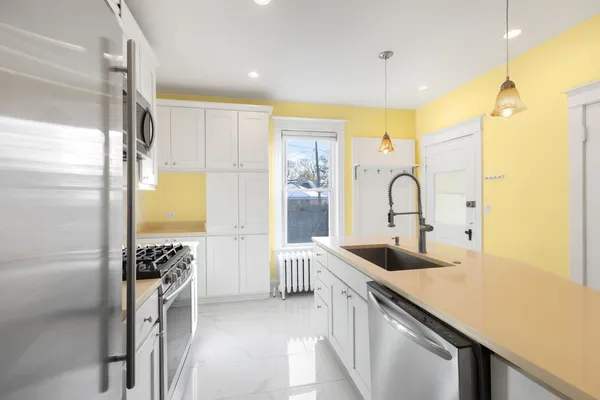 a kitchen with a sink appliances and cabinets
