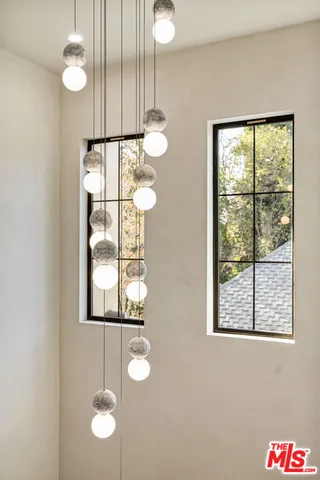 a bedroom with a bed a mirror and a dresser