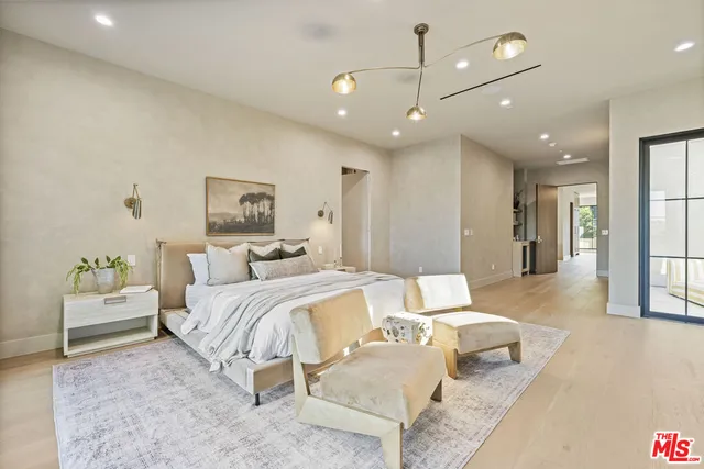 a bedroom with a bed a couch and dresser