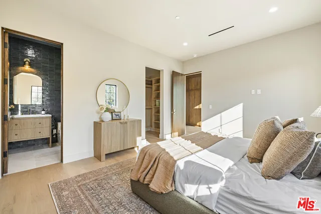 a view of a swimming pool with a lawn chairs under an umbrella