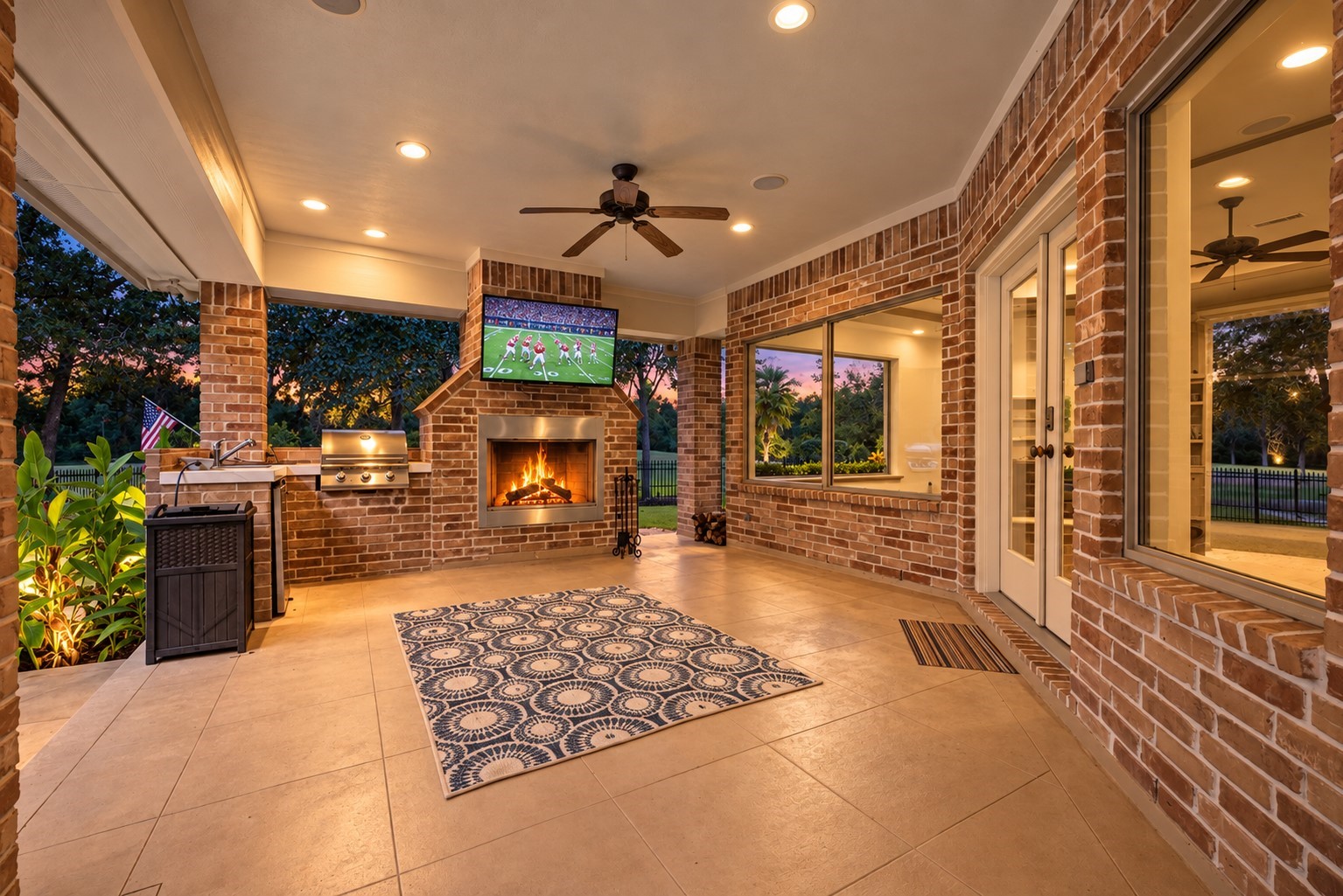 25119 Arcane Court Spring, TX 77389 - Photo 41 of 50 Outdoor Living, Texas Style! Whether enjoying wine by the fire, catching the big game outdoors, or watching the kids in the pool, this inviting covered retreat is made for year-round enjoyment. A dramatic floor-to-ceiling brick fireplace sets the mood on cooler evenings, while the outdoor television adds another layer of entertainment. Seamlessly connected to the pool and backyard, it’s the perfect extension of the home’s exceptional entertaining spaces.