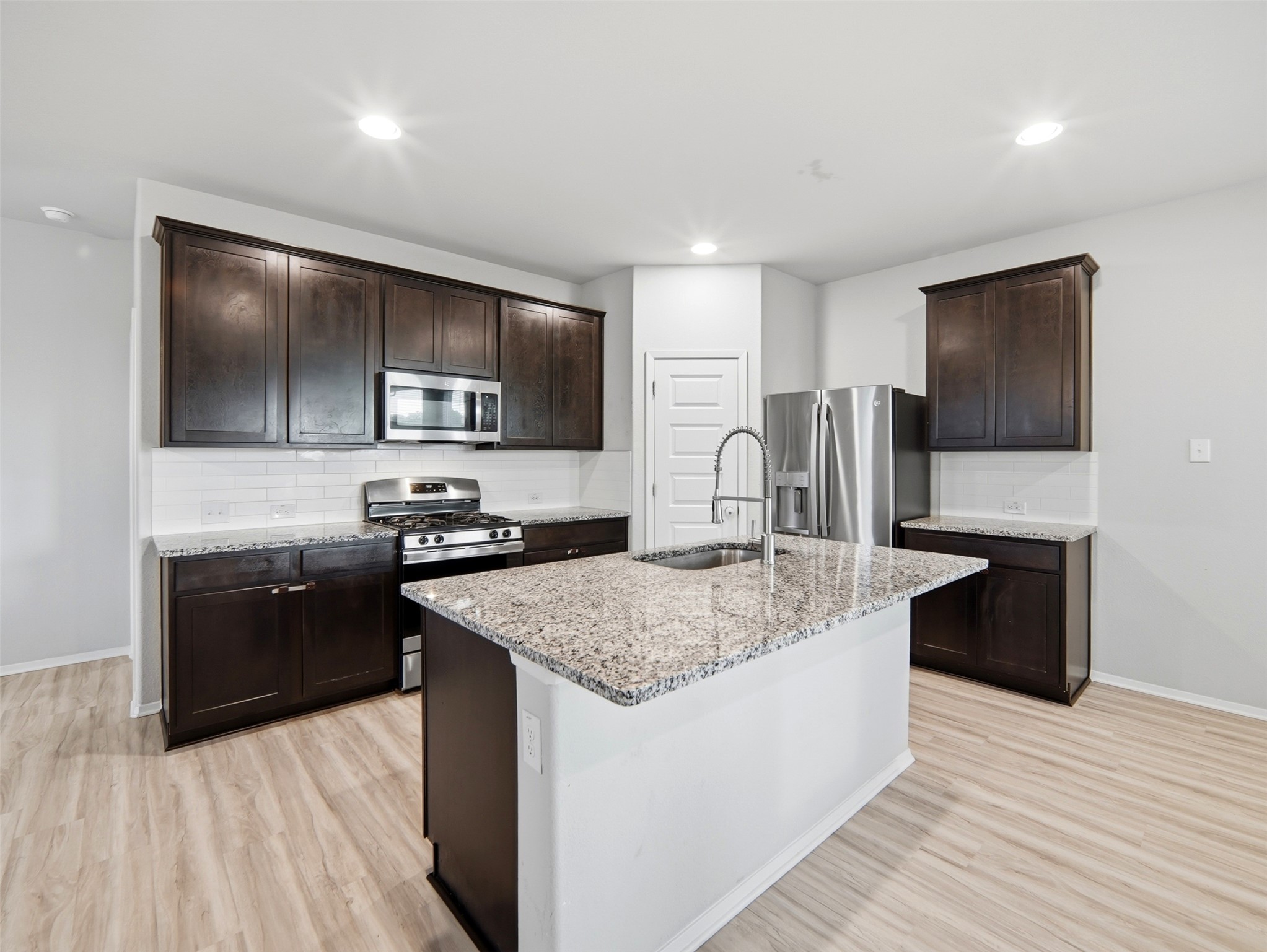 60 Bent Trl Lane Georgetown, TX 78628 - Photo 7 of 40 Culinary delights await in this contemporary kitchen featuring granite counters and stainless steel appliances.