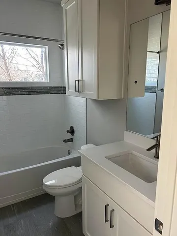 a bathroom with a toilet a sink and bathtub