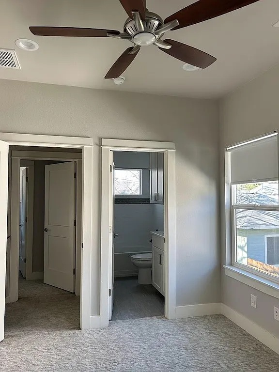 2209 Willow Street, Unit B Austin, TX 78702 - Photo 8 of 16 a view of a room with a ceiling fan and a window