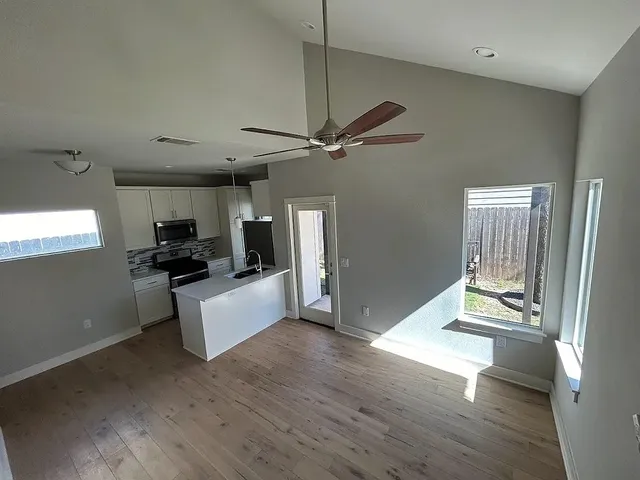 a living room with furniture and a wooden floor