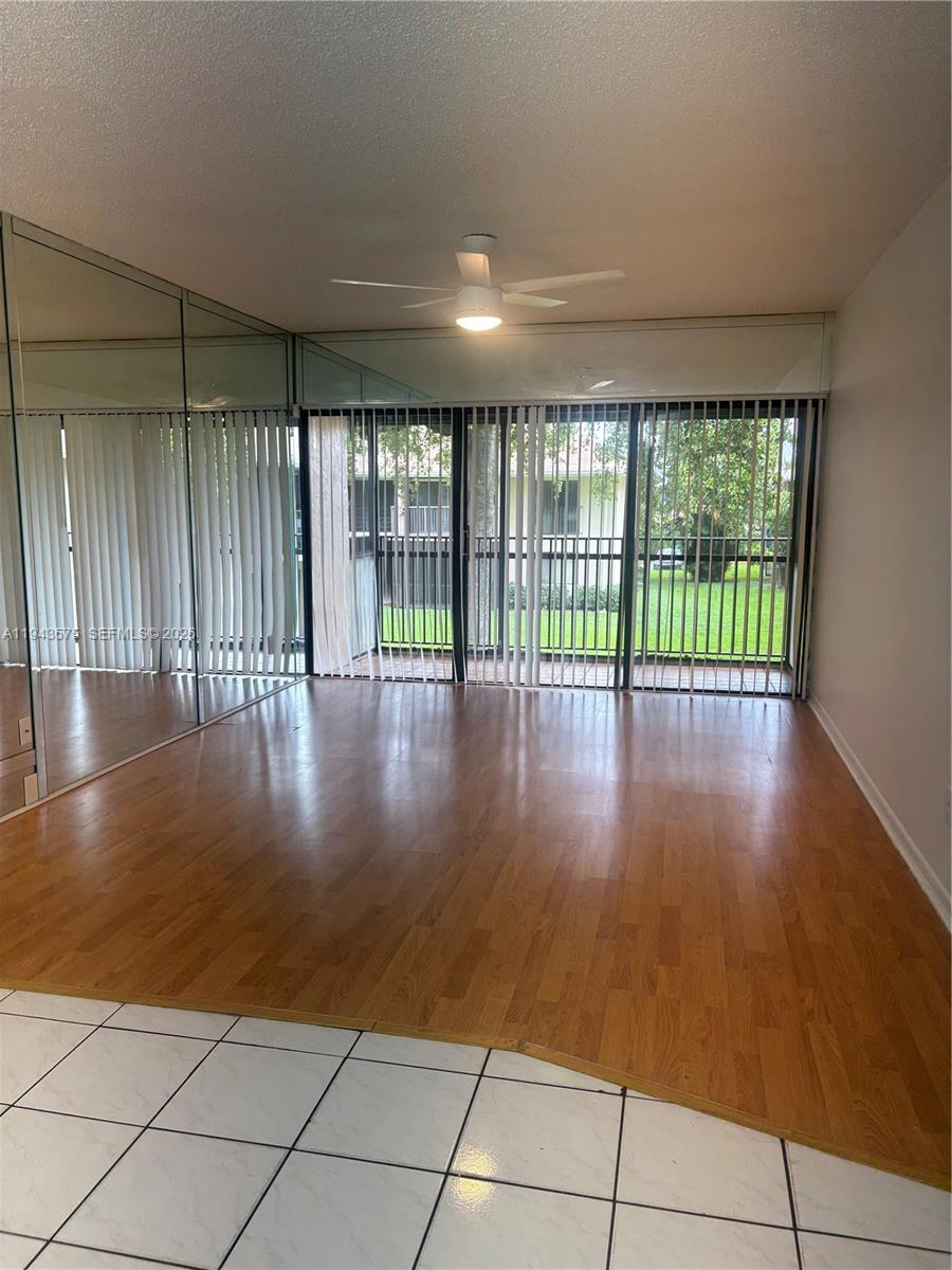 5981 Washington Street, Unit 215 Hollywood, FL 33023 - Photo 22 of 24 a view of an empty room with wooden floor and a window