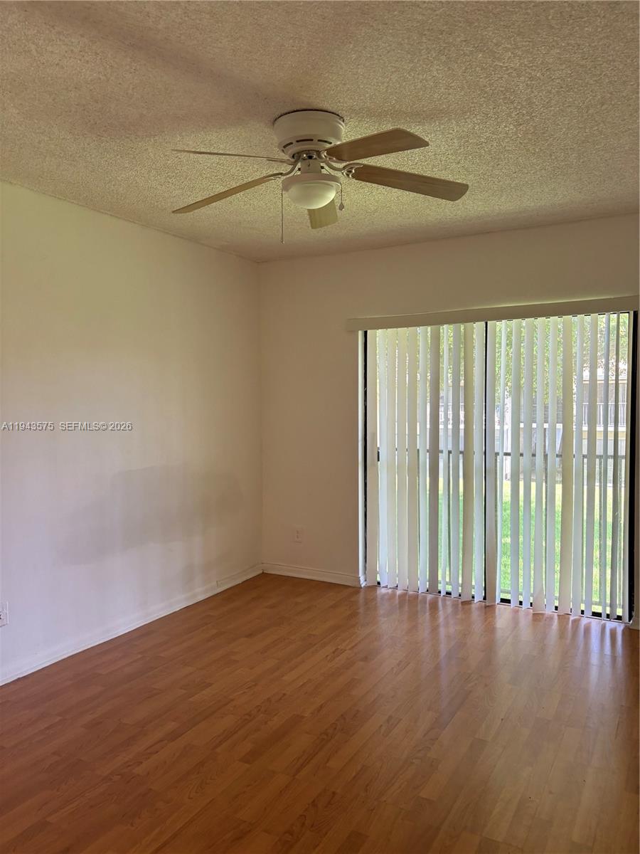 5981 Washington Street, Unit 215 Hollywood, FL 33023 - Photo 6 of 24 wooden floor in an empty room with a window