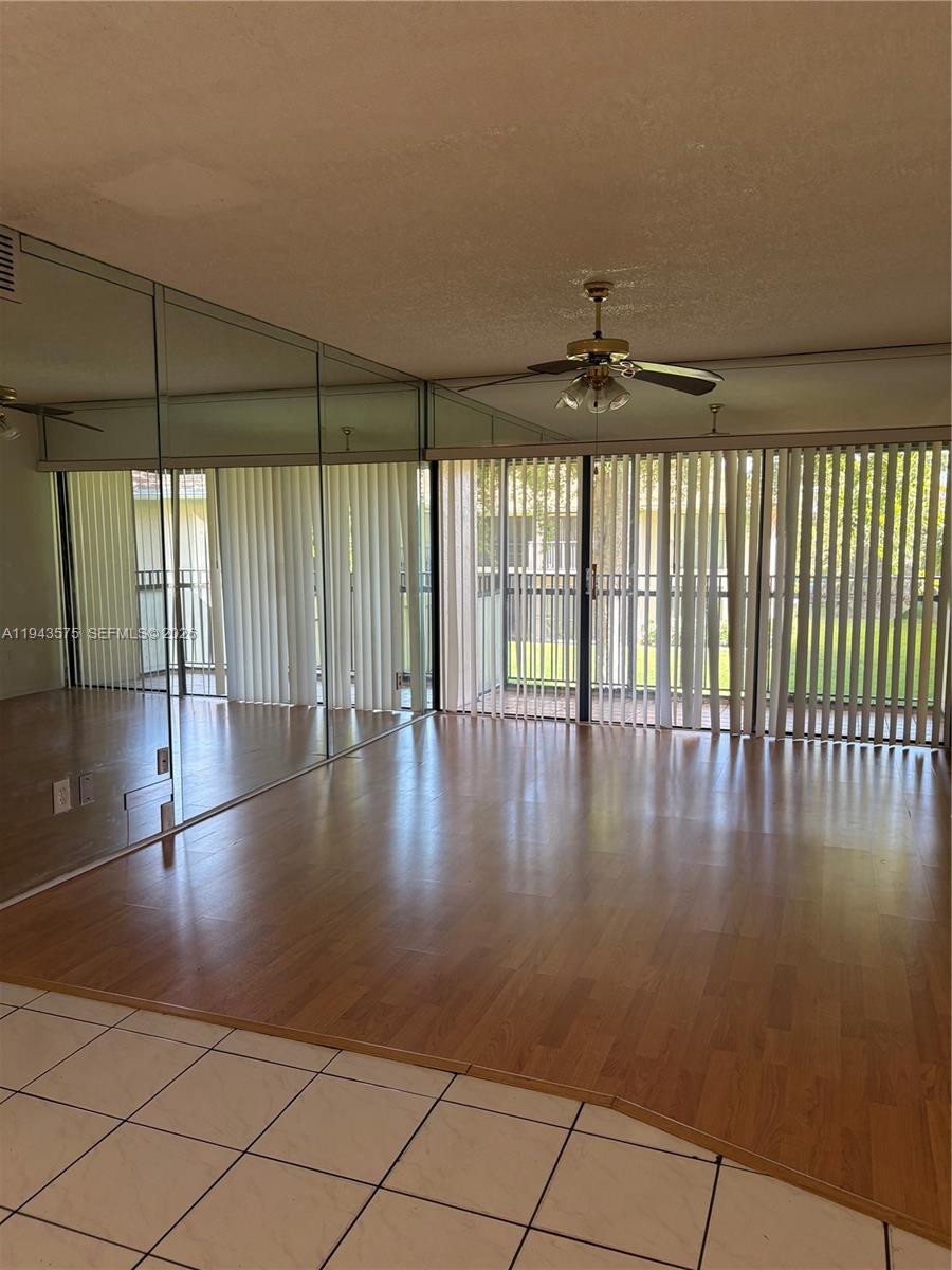 5981 Washington Street, Unit 215 Hollywood, FL 33023 - Photo 10 of 24 an empty room with wooden floor and windows