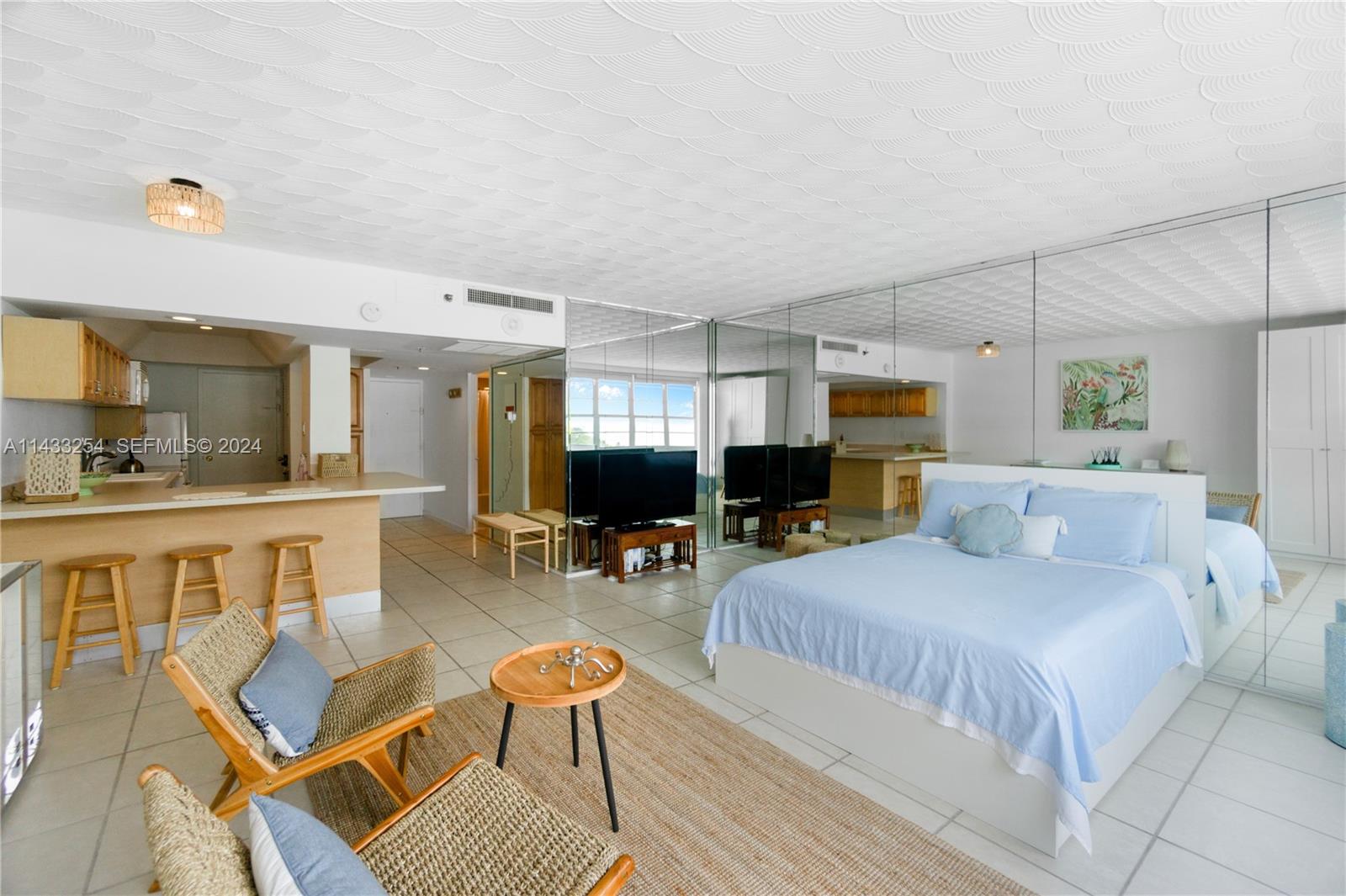 100 Lincoln Road, Unit 1039 Miami Beach, FL 33139 - Photo 8 of 26 a bedroom with furniture and a wooden floor