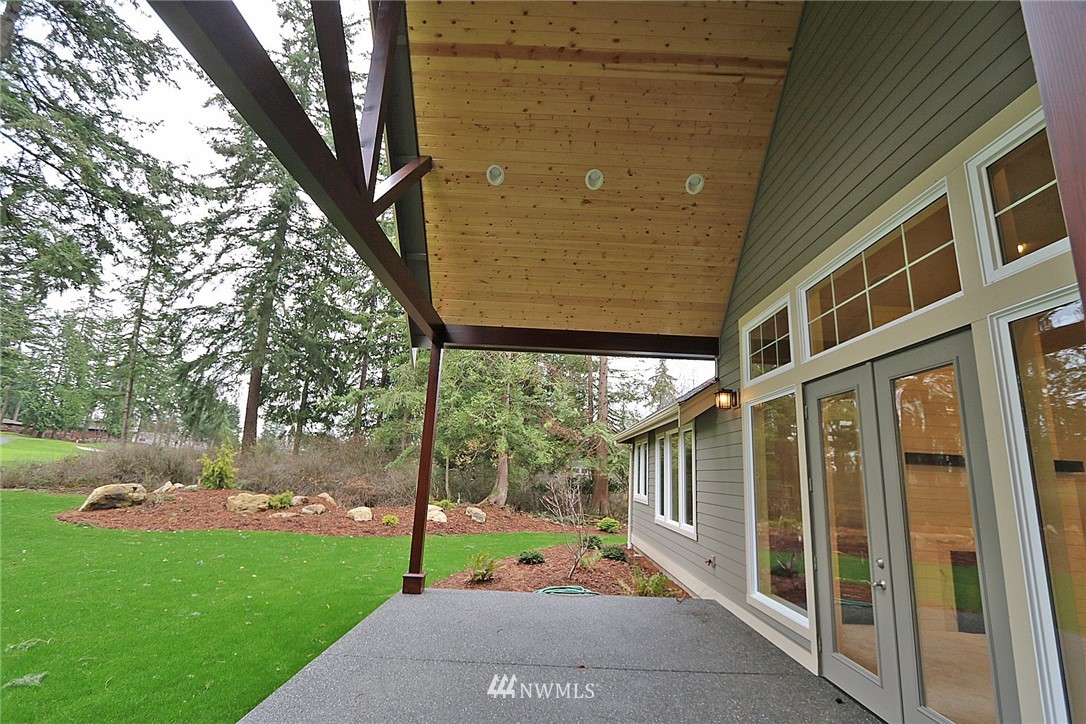 8826 Goshawk Road Blaine, WA 98230 - Photo 22 of 24 a view of a porch with a floor to ceiling window and a yard
