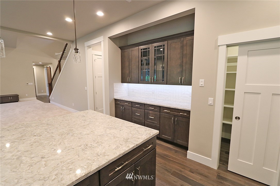 8826 Goshawk Road Blaine, WA 98230 - Photo 5 of 24 a kitchen with a sink a refrigerator and wooden floor