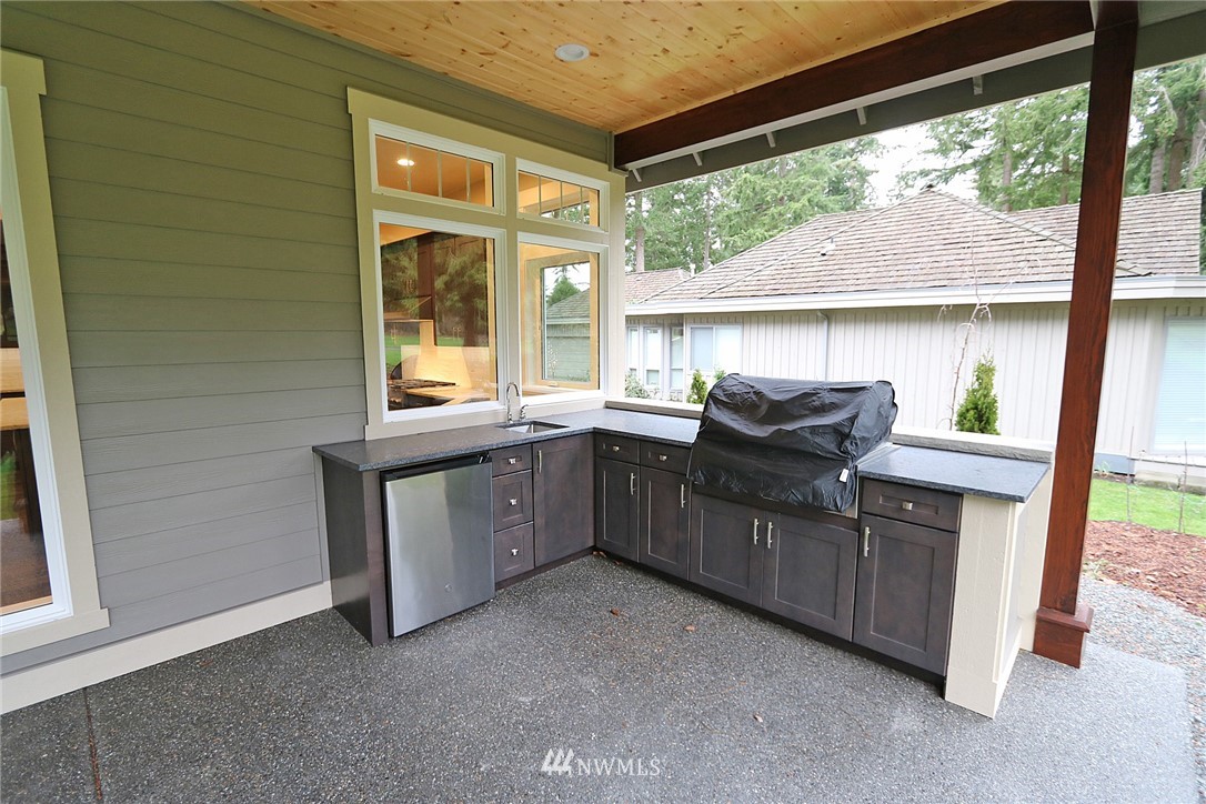 8826 Goshawk Road Blaine, WA 98230 - Photo 8 of 24 a kitchen that has a sink and a stove