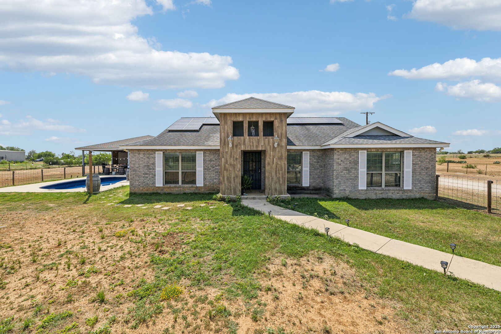 a front view of a house with a yard