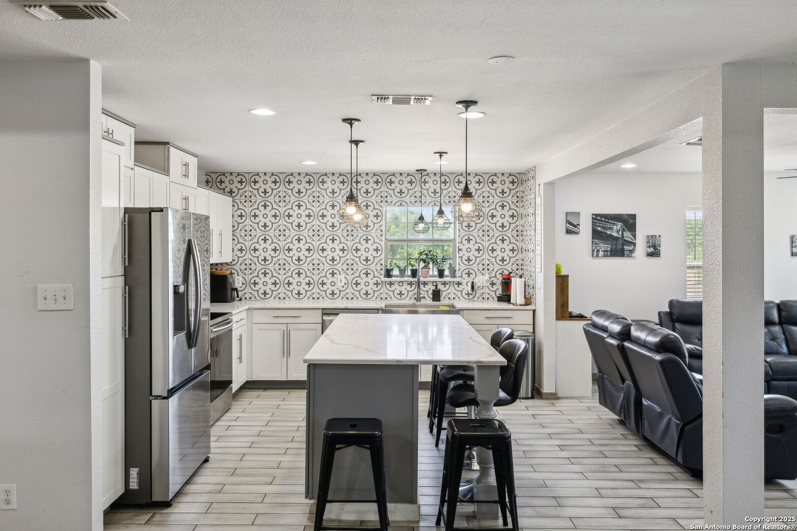 2355 Stuart Road Adkins, TX 78101 - Photo 11 of 46 a kitchen with stainless steel appliances granite countertop a table chairs stove and refrigerator