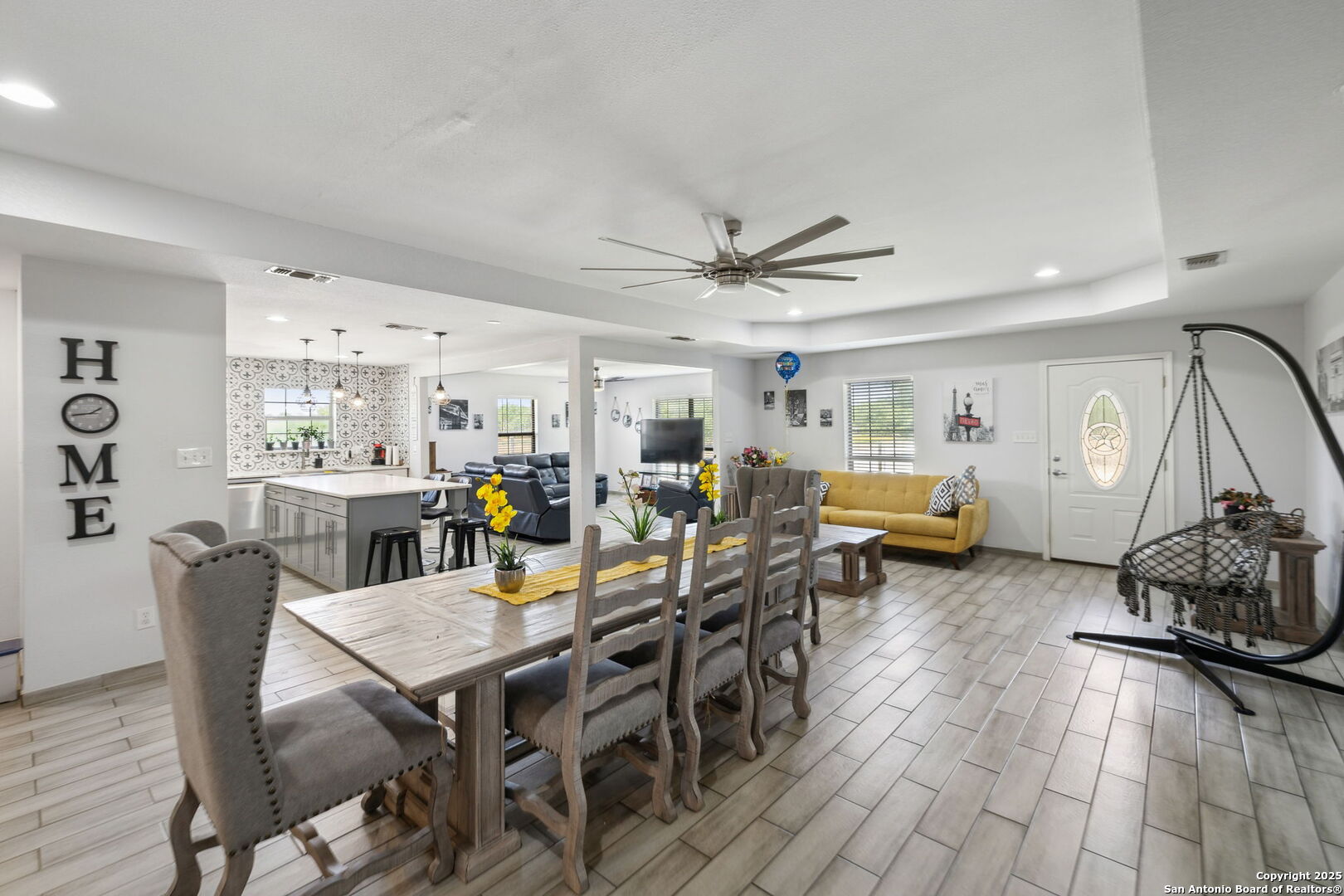 2355 Stuart Road Adkins, TX 78101 - Photo 12 of 46 a view of a dining room and livingroom with furniture wooden floor a rug a painting and a chandelier
