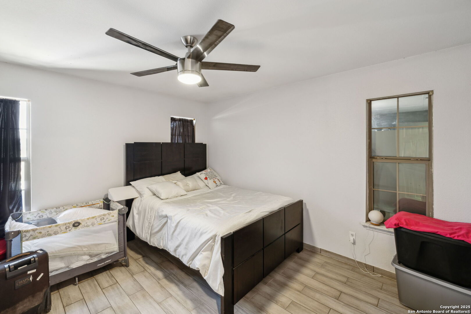 2355 Stuart Road Adkins, TX 78101 - Photo 24 of 46 a bedroom with a bed and a chandelier