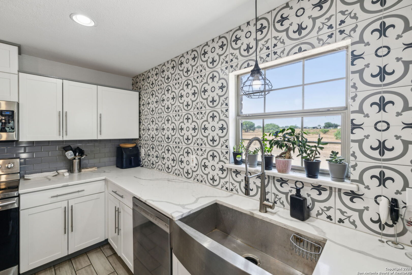 2355 Stuart Road Adkins, TX 78101 - Photo 6 of 46 a kitchen with a sink and a stove
