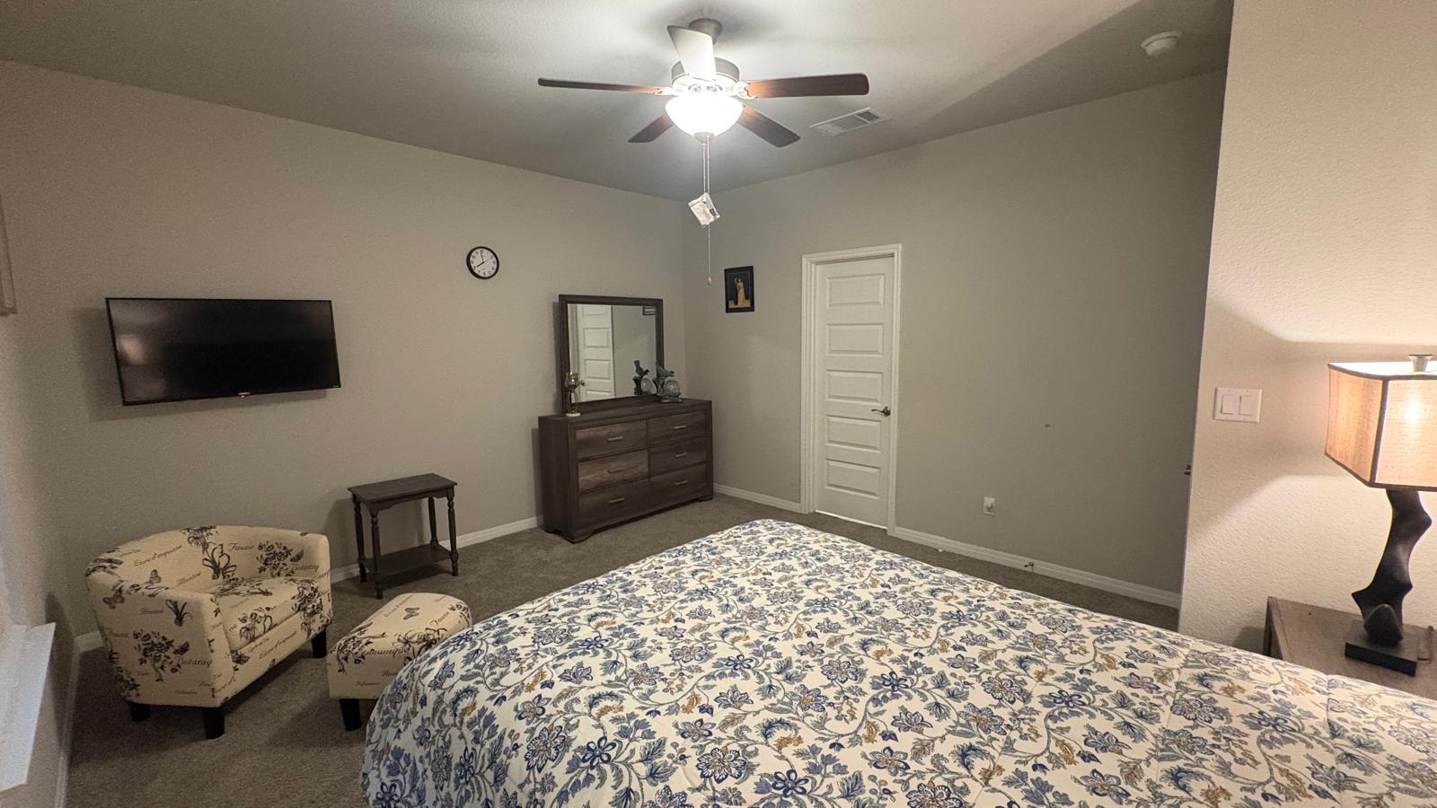 6511 Dragride Road Buda, TX 78610 - Photo 17 of 36 Relax in comfort with a ceiling fan overhead and soft carpet underfoot in this cozy sleeping area.