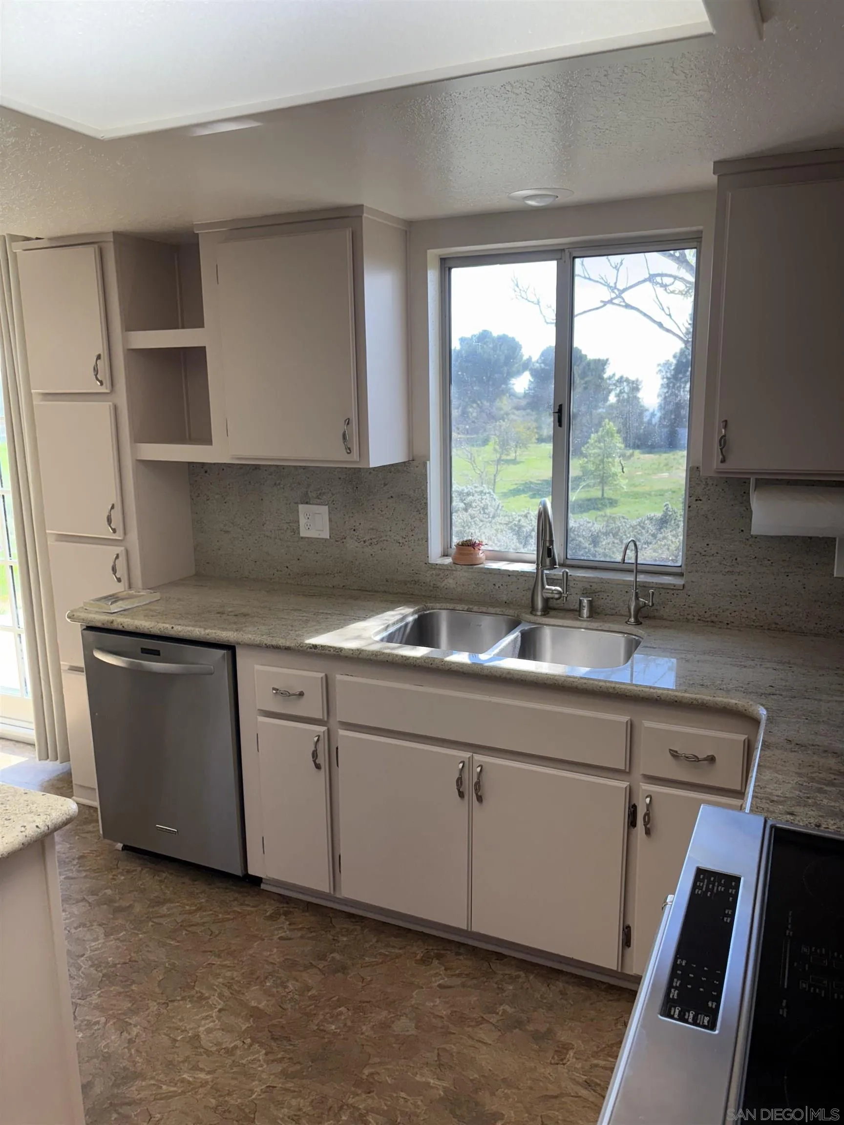 6702 Rainbow Heights Road Rainbow, CA 92028 - Photo 14 of 37 a kitchen with granite countertop a sink and a stove