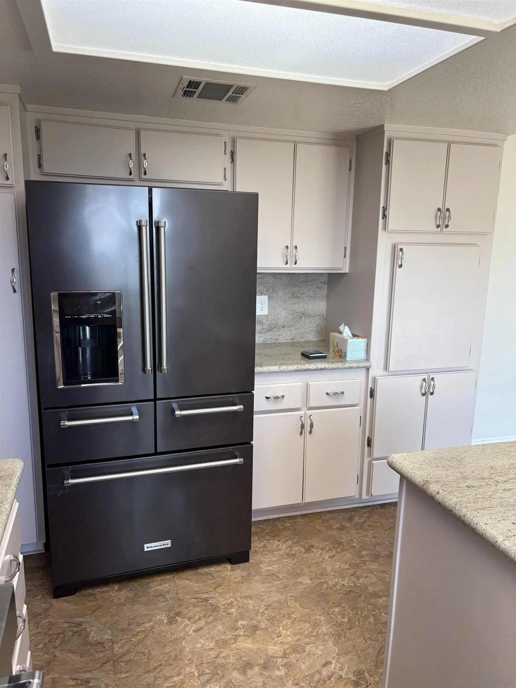 6702 Rainbow Heights Road Rainbow, CA 92028 - Photo 17 of 37 a kitchen with a refrigerator and cabinets