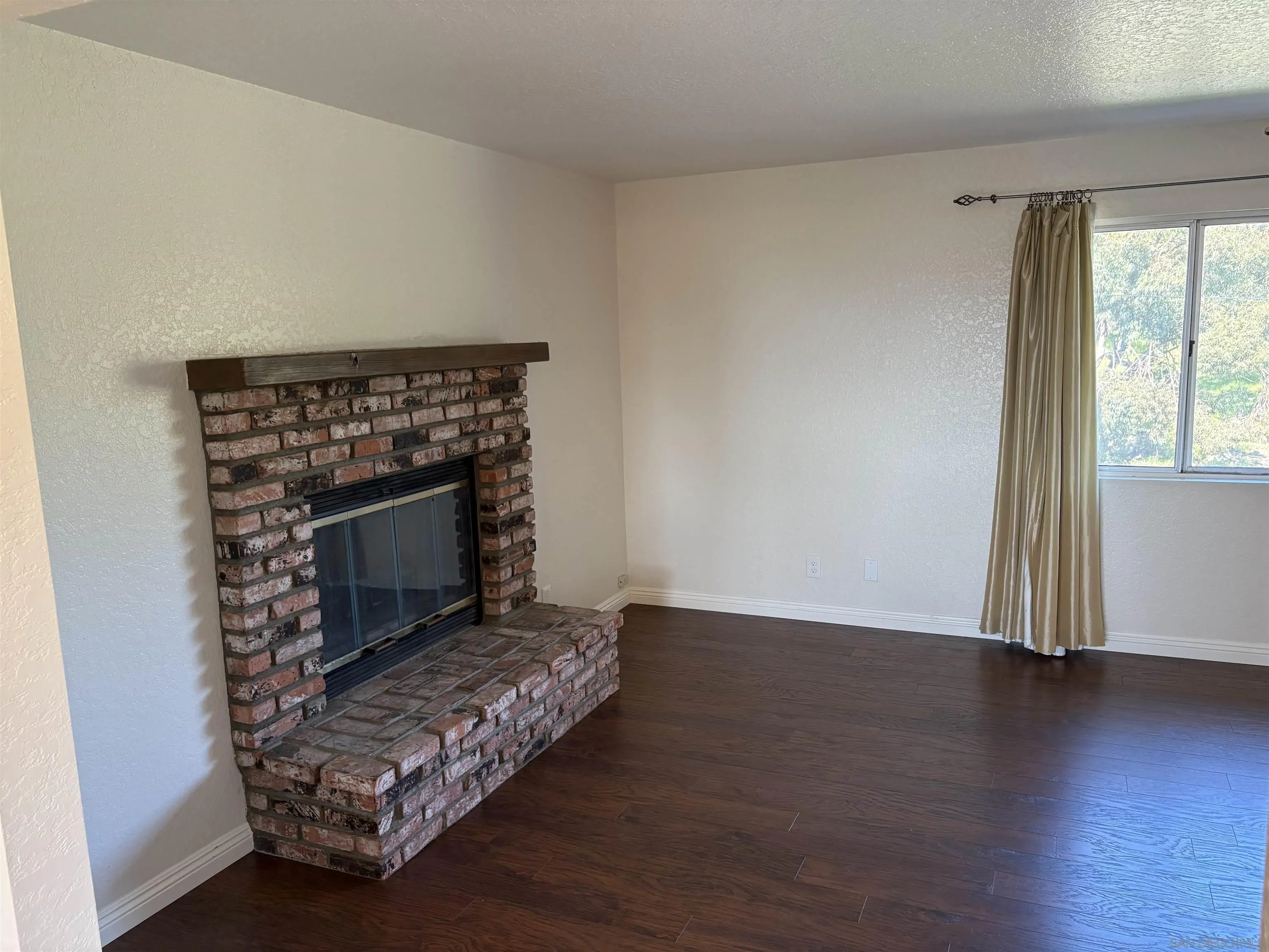 6702 Rainbow Heights Road Rainbow, CA 92028 - Photo 19 of 37 a living room with a fireplace
