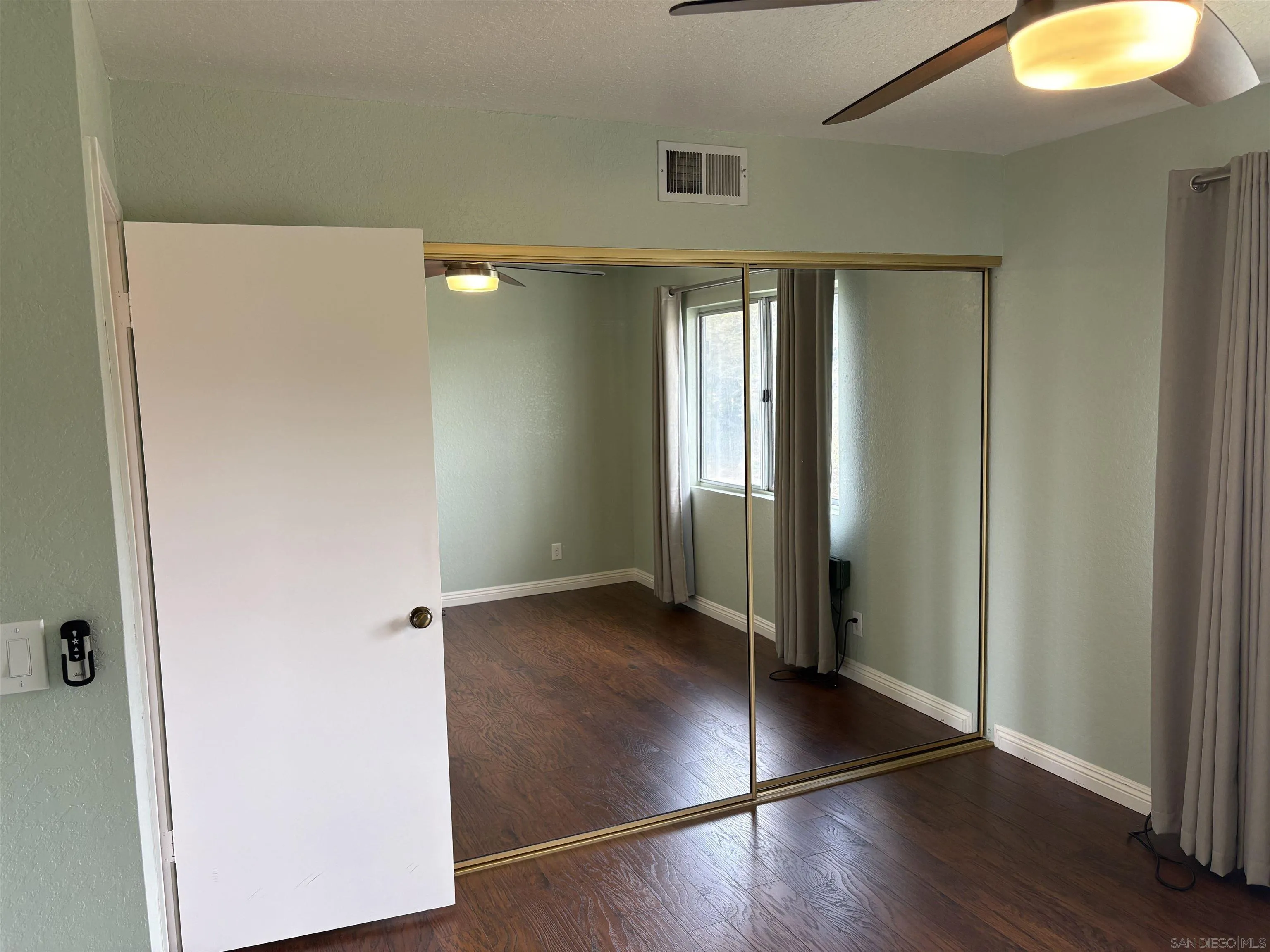 6702 Rainbow Heights Road Rainbow, CA 92028 - Photo 24 of 37 an empty room with wooden floor and windows