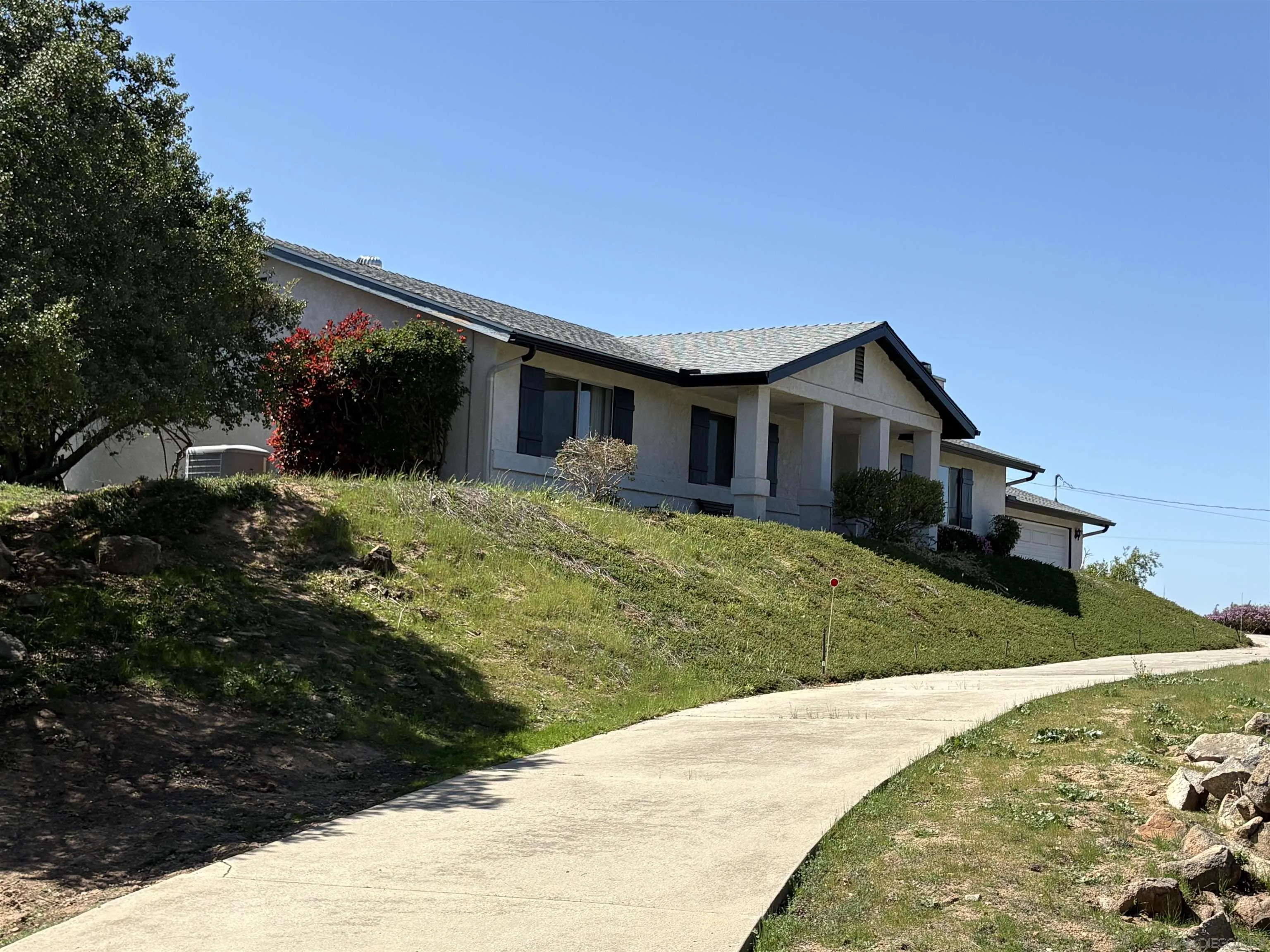 6702 Rainbow Heights Road Rainbow, CA 92028 - Photo 3 of 37 a view of a house with a yard