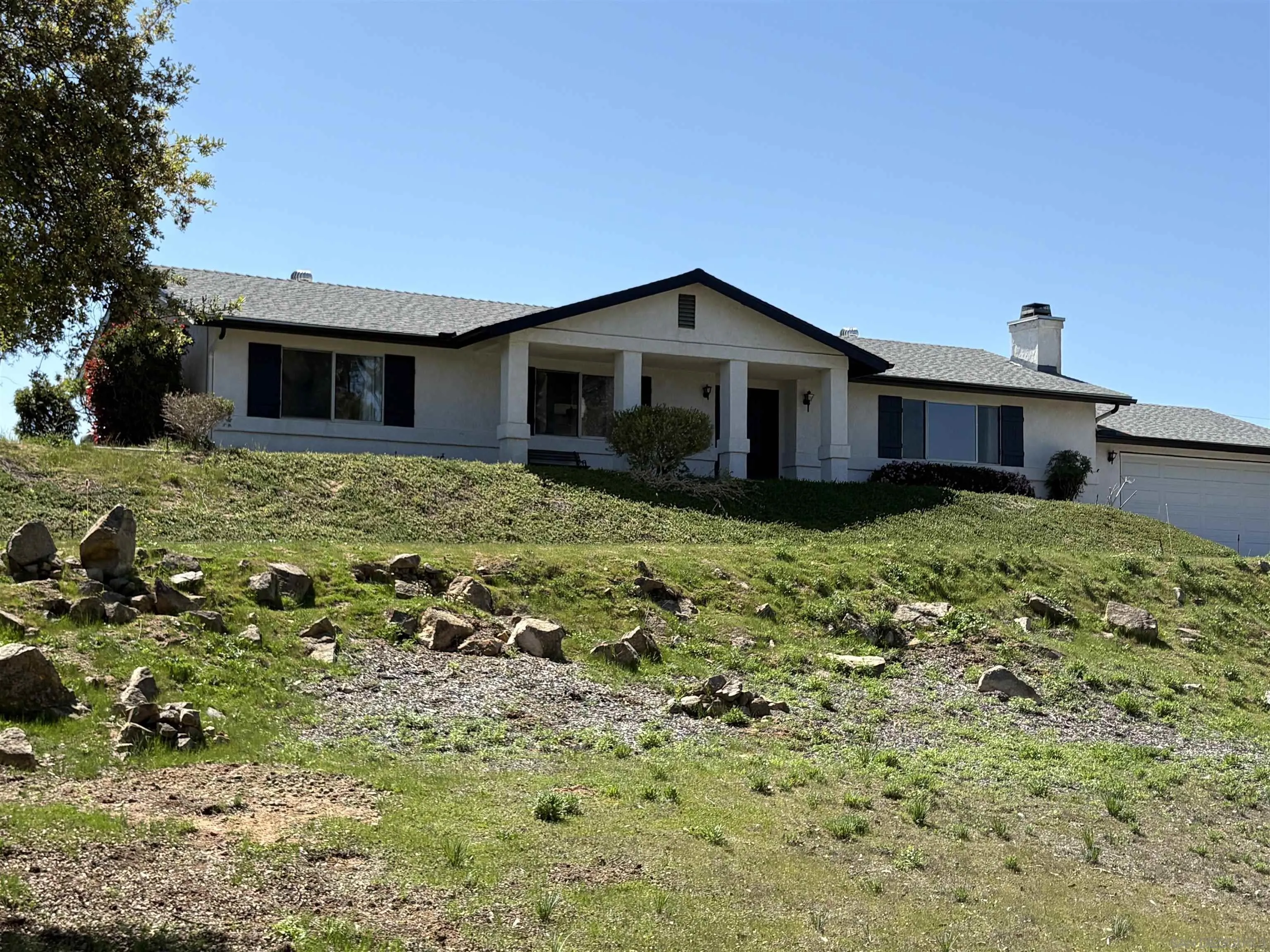 6702 Rainbow Heights Road Rainbow, CA 92028 - Photo 4 of 37 a view of a house with a yard