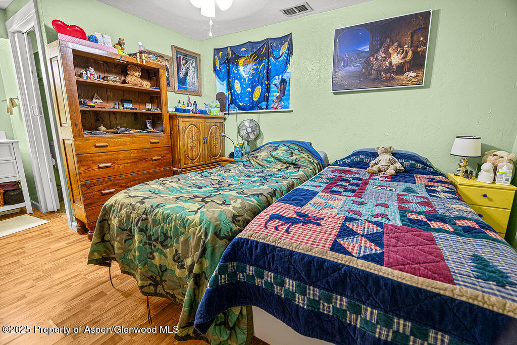 834 Ashley Road Craig, CO 81625 - Photo 14 of 38 a bedroom with a bed and dresser