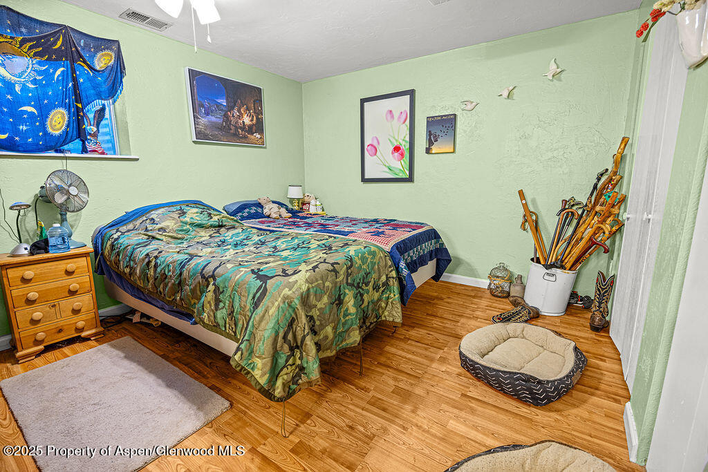 834 Ashley Road Craig, CO 81625 - Photo 15 of 38 a bedroom with a bed and painting on the wall
