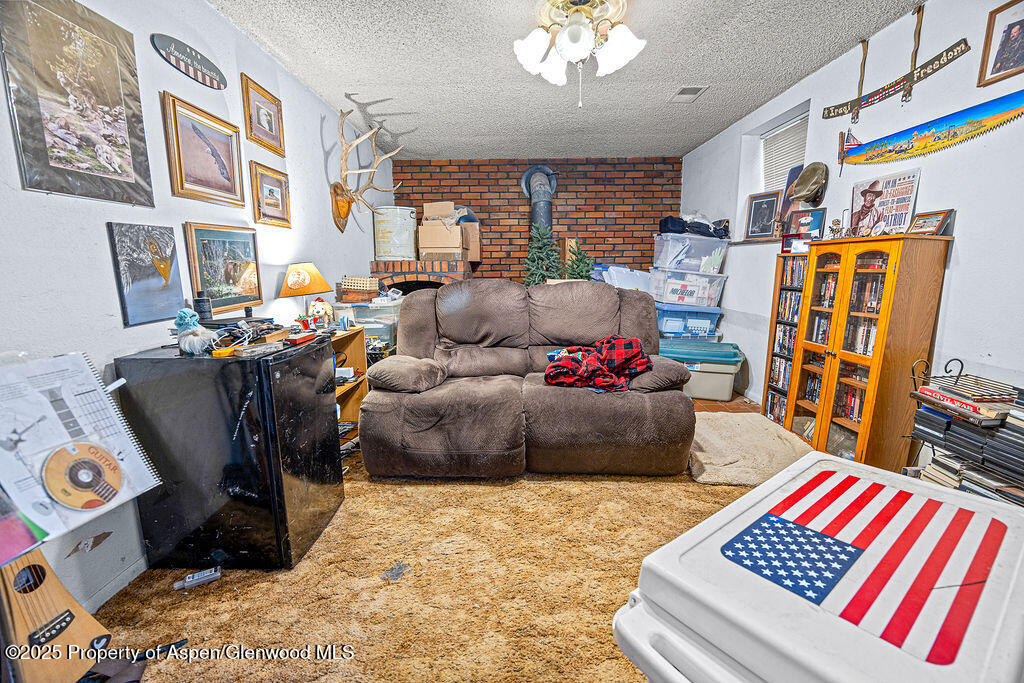 834 Ashley Road Craig, CO 81625 - Photo 16 of 38 a living room with furniture fireplace and rug