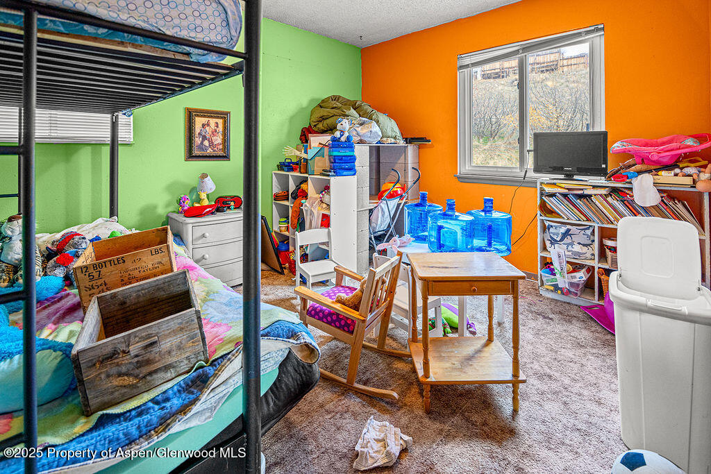 834 Ashley Road Craig, CO 81625 - Photo 18 of 38 a bedroom with furniture and a baby crib