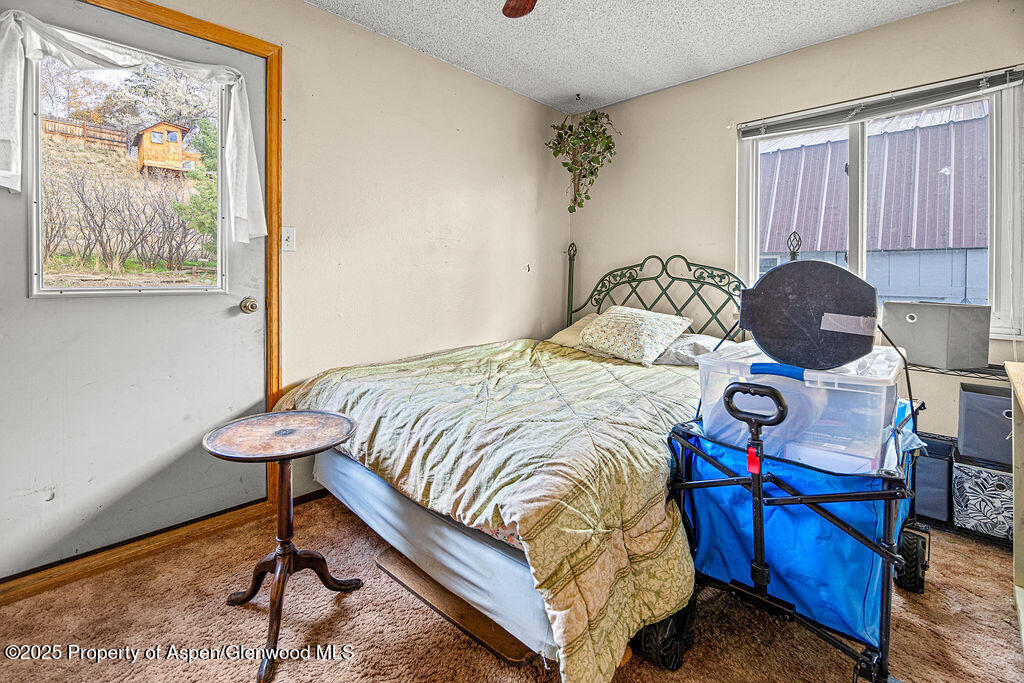 834 Ashley Road Craig, CO 81625 - Photo 20 of 38 a bedroom with a bed and wooden floor