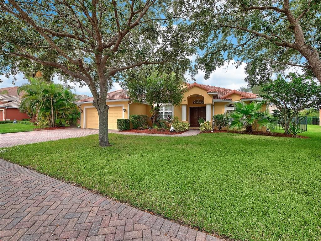 1945 Southwest Panther Trace Stuart, FL 34997 - Photo 1 of 18 a front view of house with yard and green space