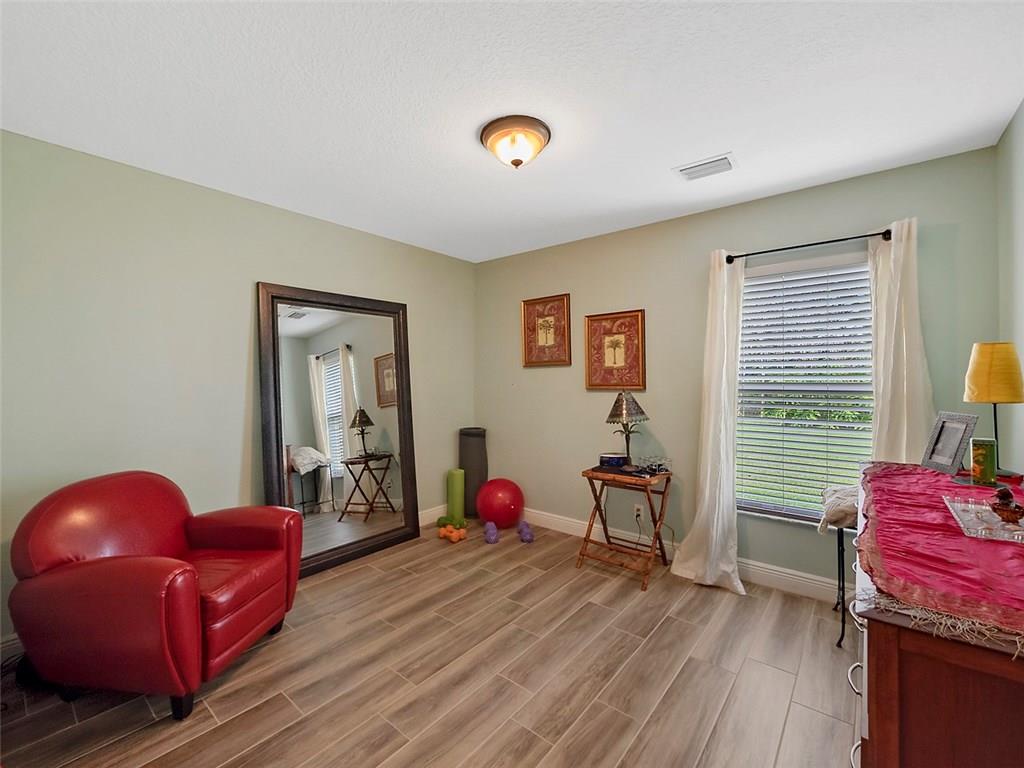 1945 Southwest Panther Trace Stuart, FL 34997 - Photo 11 of 18 a bedroom with furniture and a window